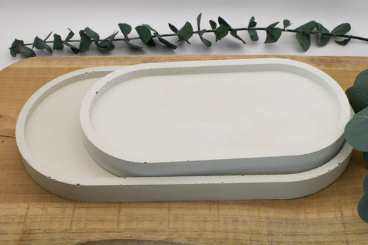 Ovale Tabletts aus hellgrauem Feinbeton in zwei Größen – moderne Deko für Vasen, Kerzen oder Schmuck.