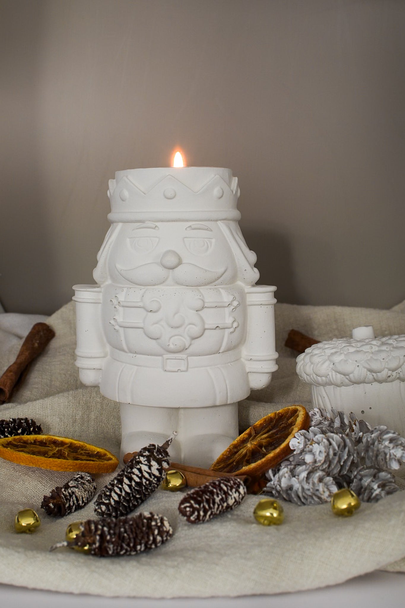 weihnachtliche Tischdeko, ein Nussknacker aus Beton als Teelichthalter